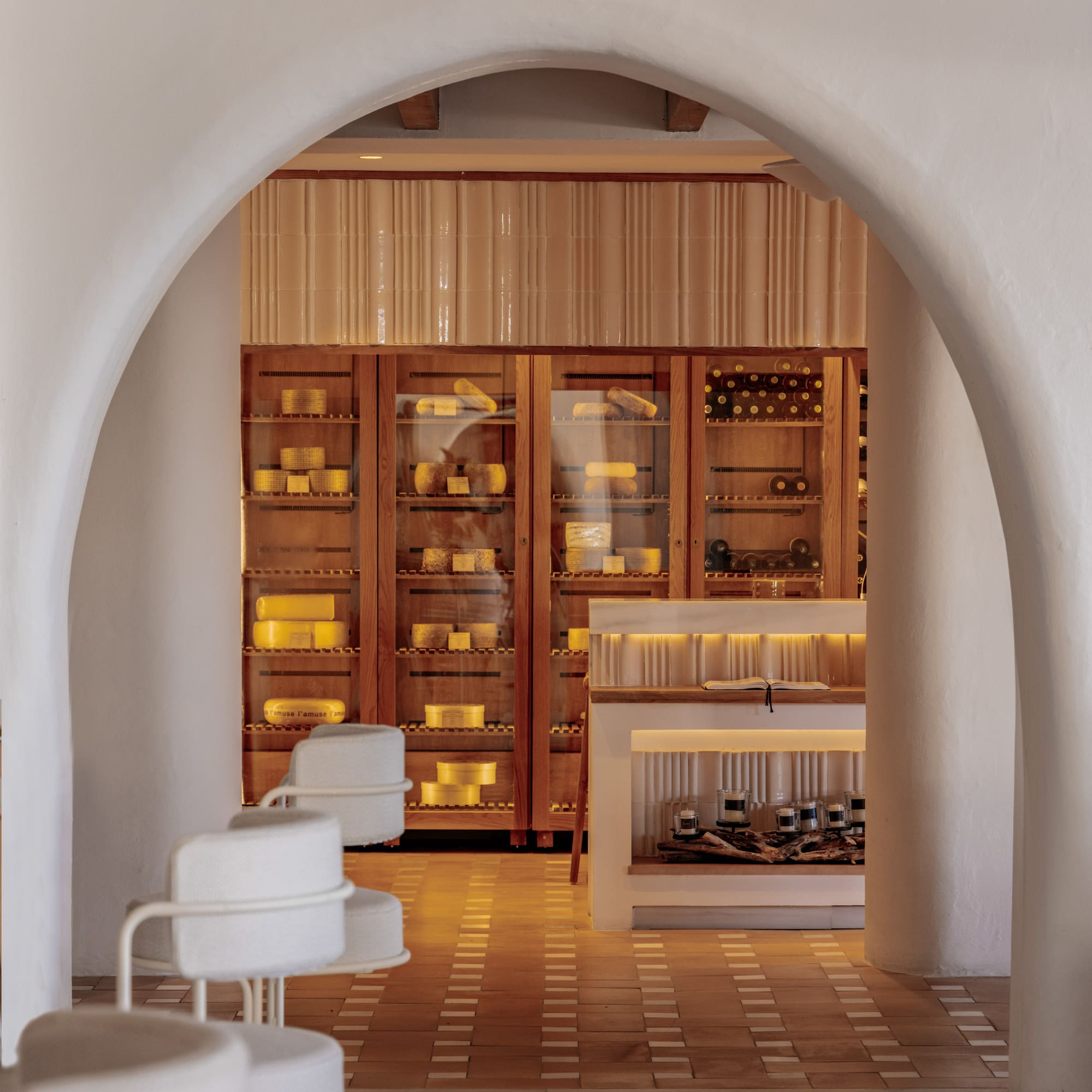 a white archway with a shelf and shelves in front of it