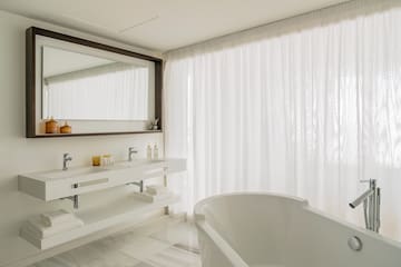 a bathroom with a bathtub and a mirror
