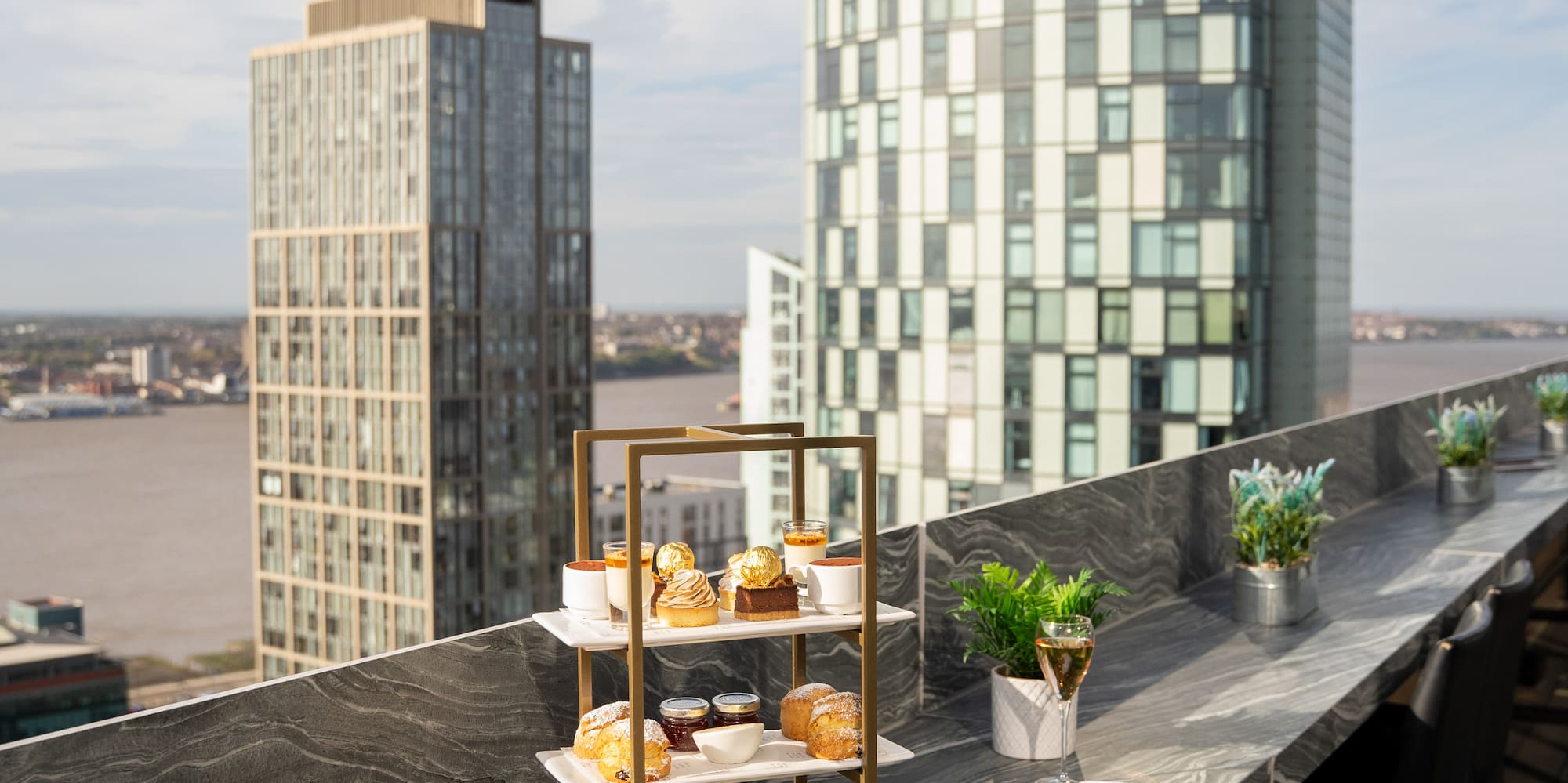 a table with food on it and a glass of wine on it