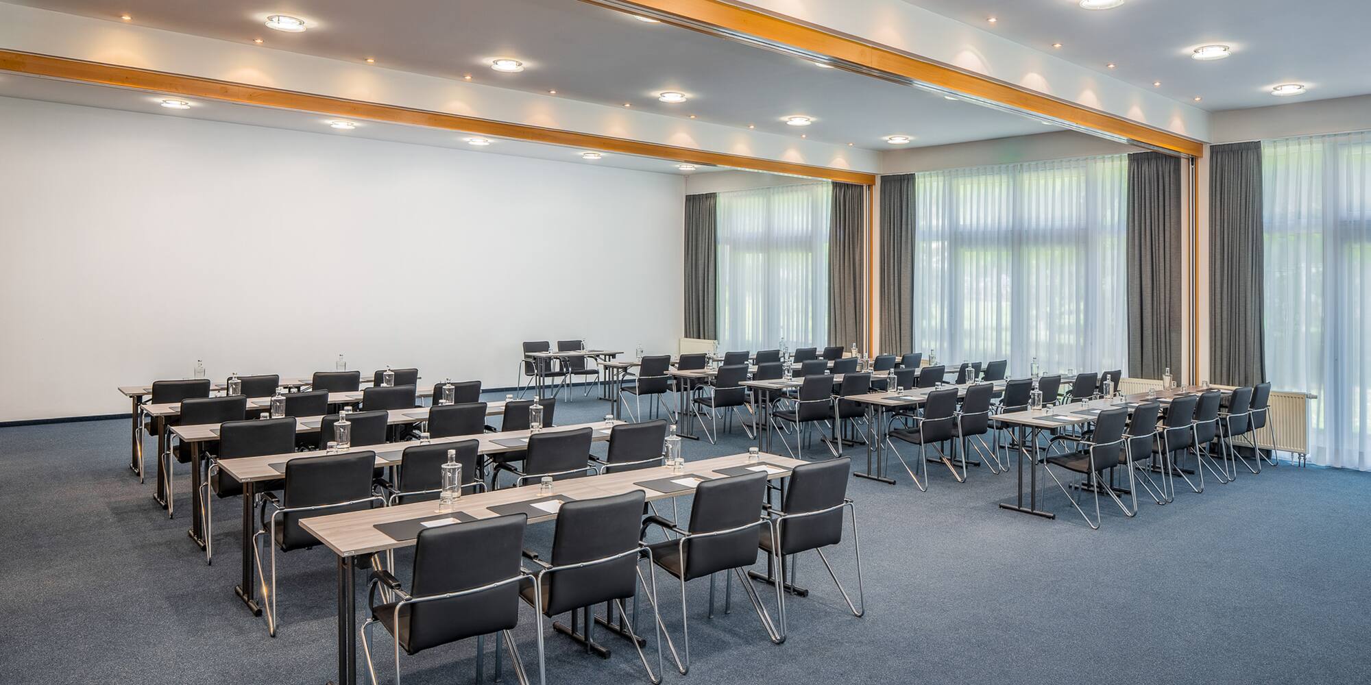 a room with many chairs and tables