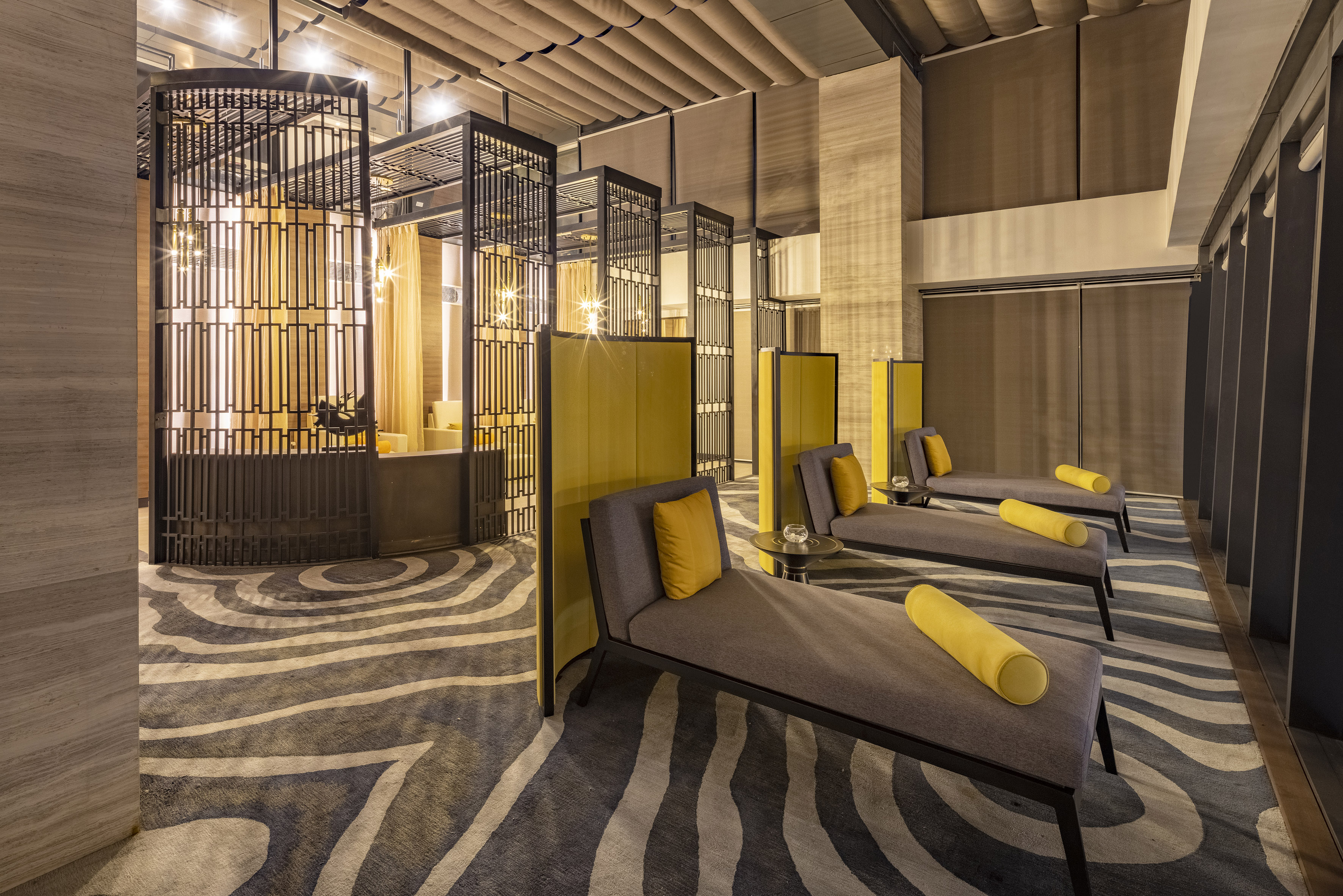 Luxury spa lounge with chaise lounges, wavy patterned rug, and geometric metal screens. - YHI Spa - Meliá Vinpearl Thanh Hoa, Thanh Hoa