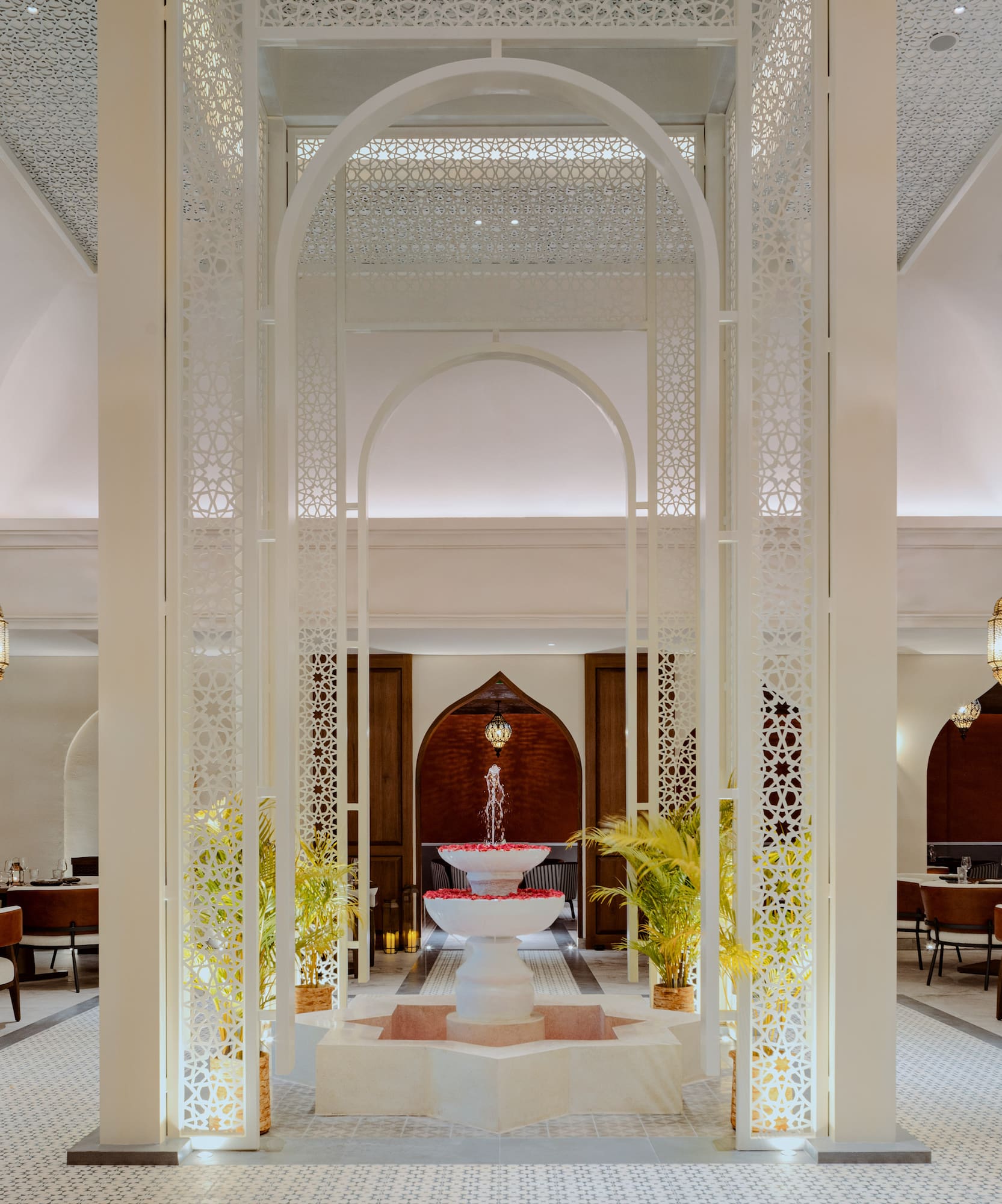 a room with a fountain and tables