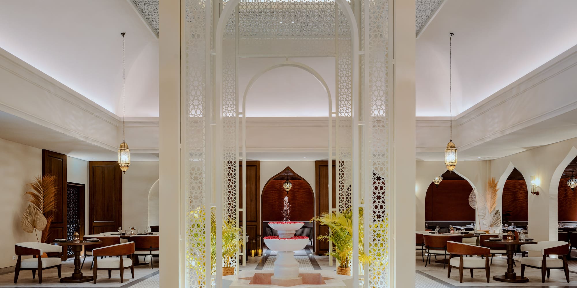 a room with a fountain and tables