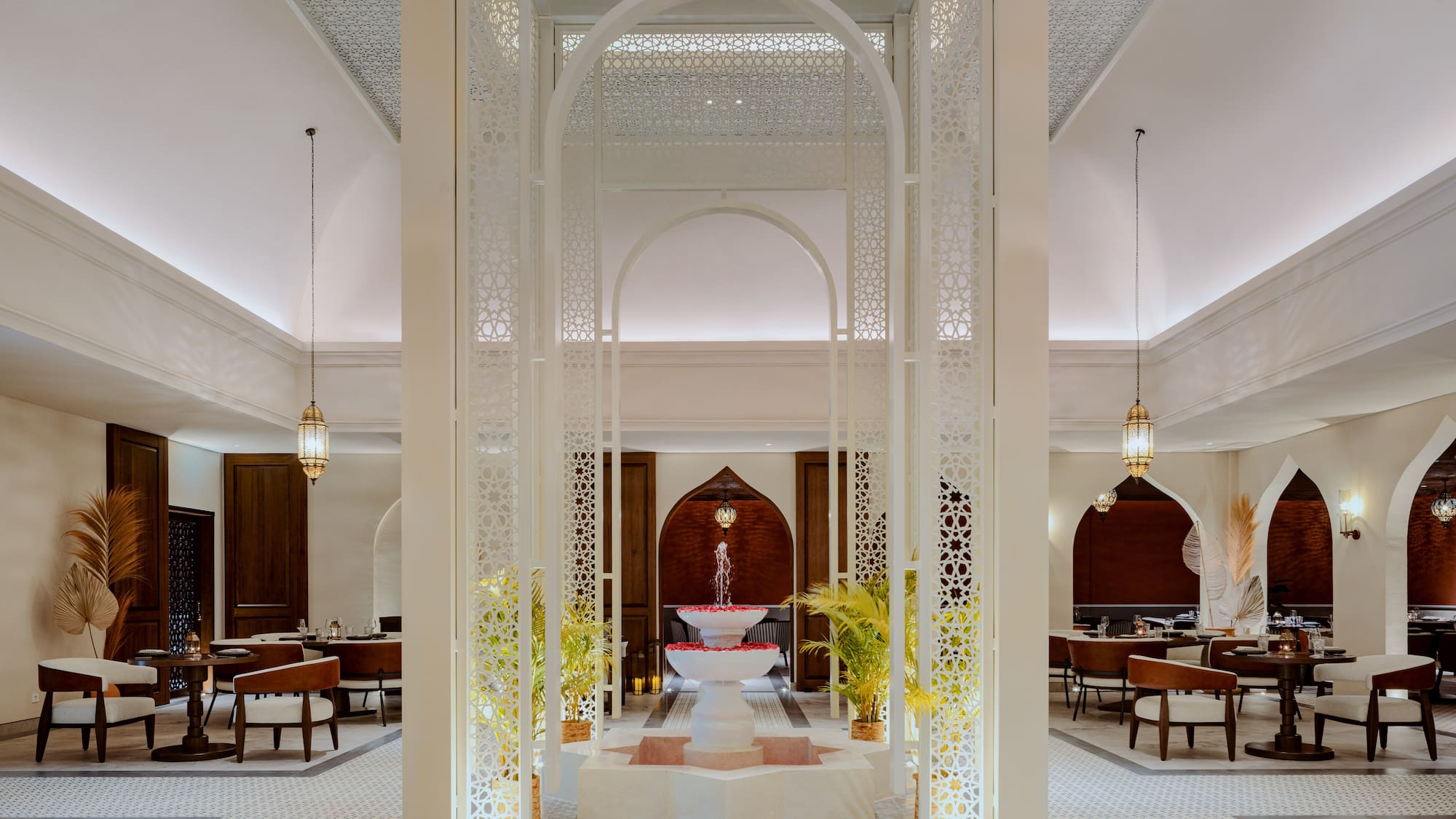 a room with a fountain and tables