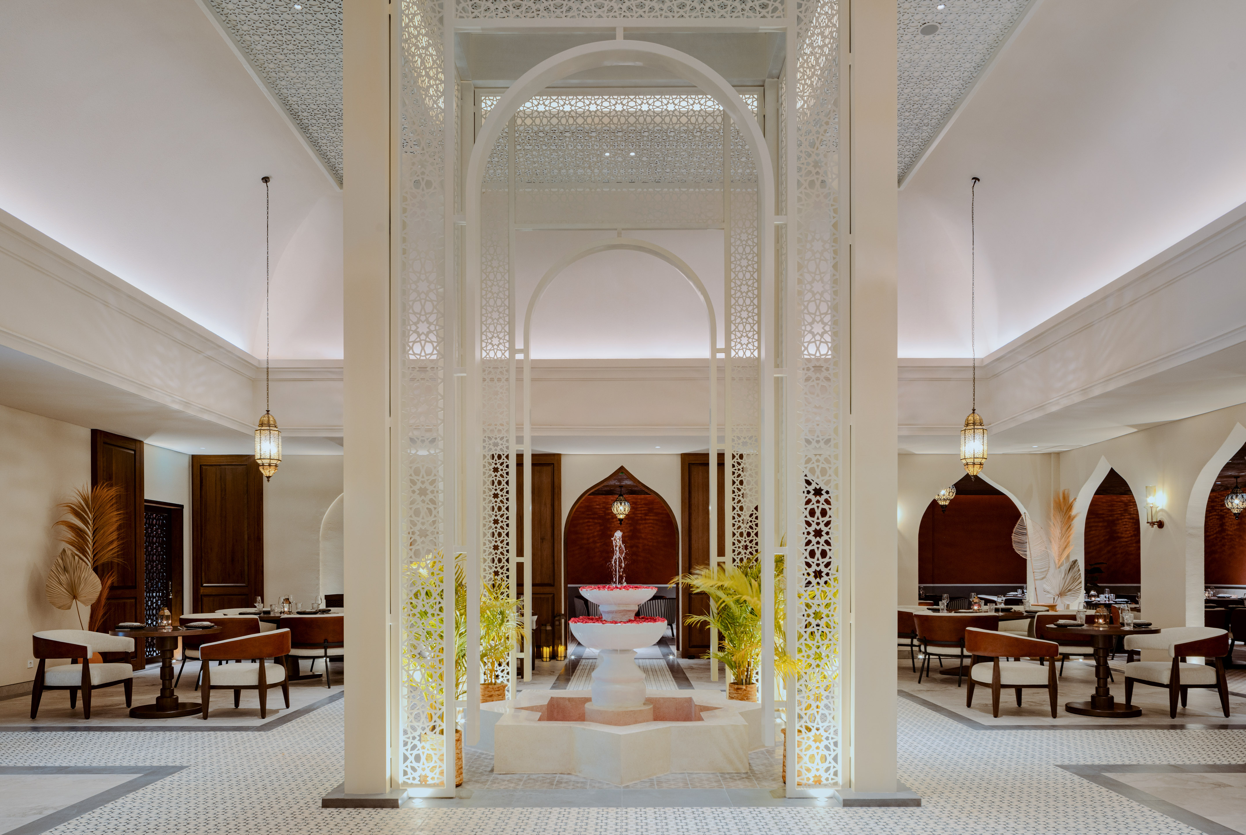 a room with a fountain and tables