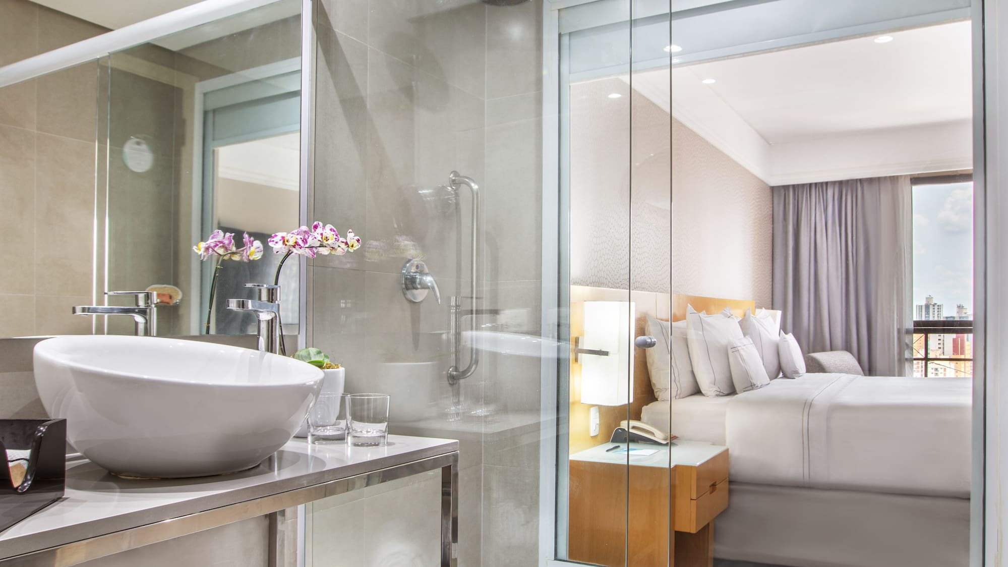 a bathroom with a glass shower and a sink