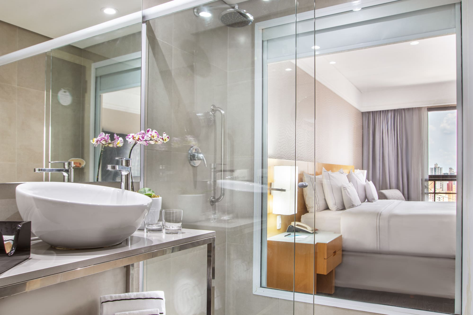 a bathroom with a glass shower and a sink