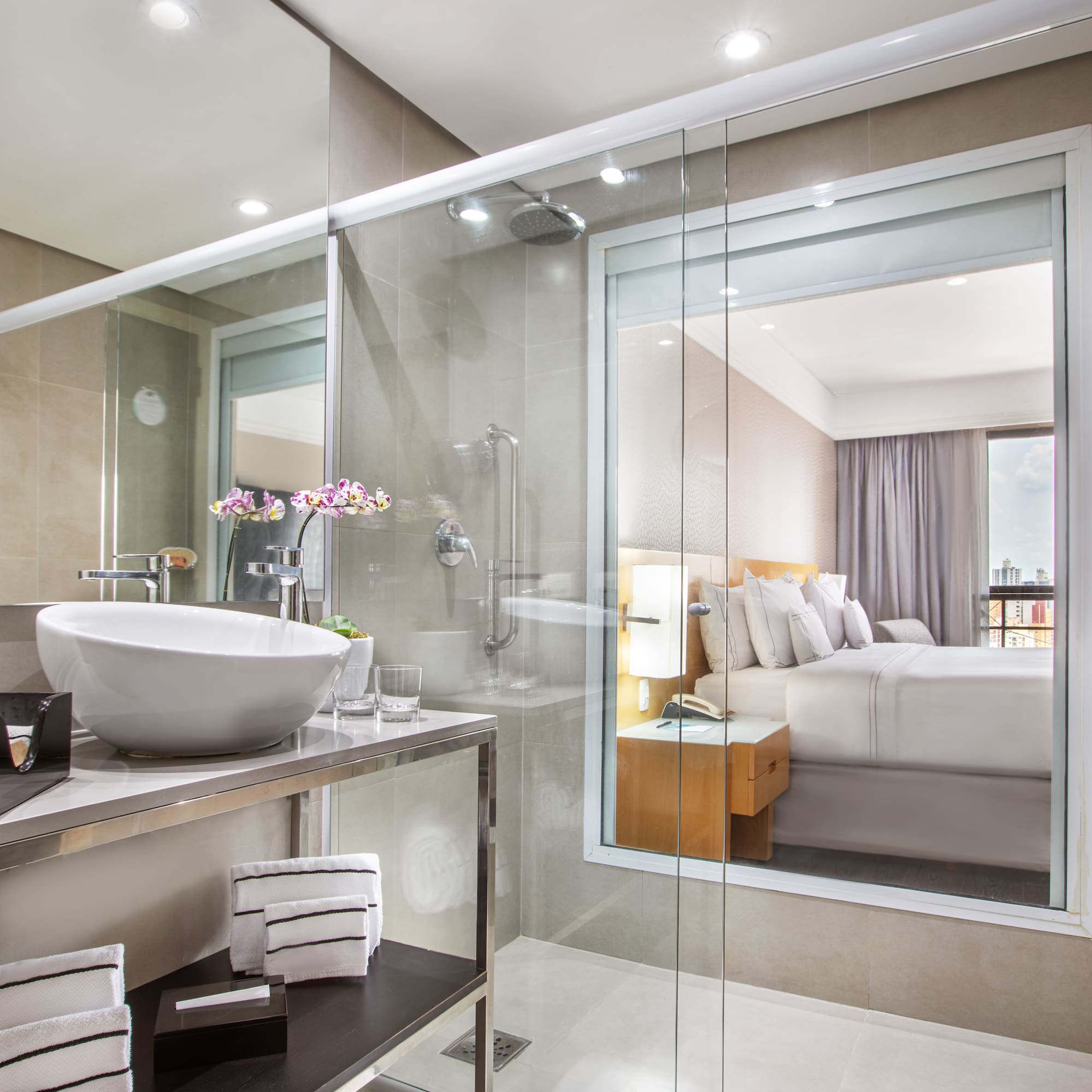 a bathroom with a glass shower and a sink