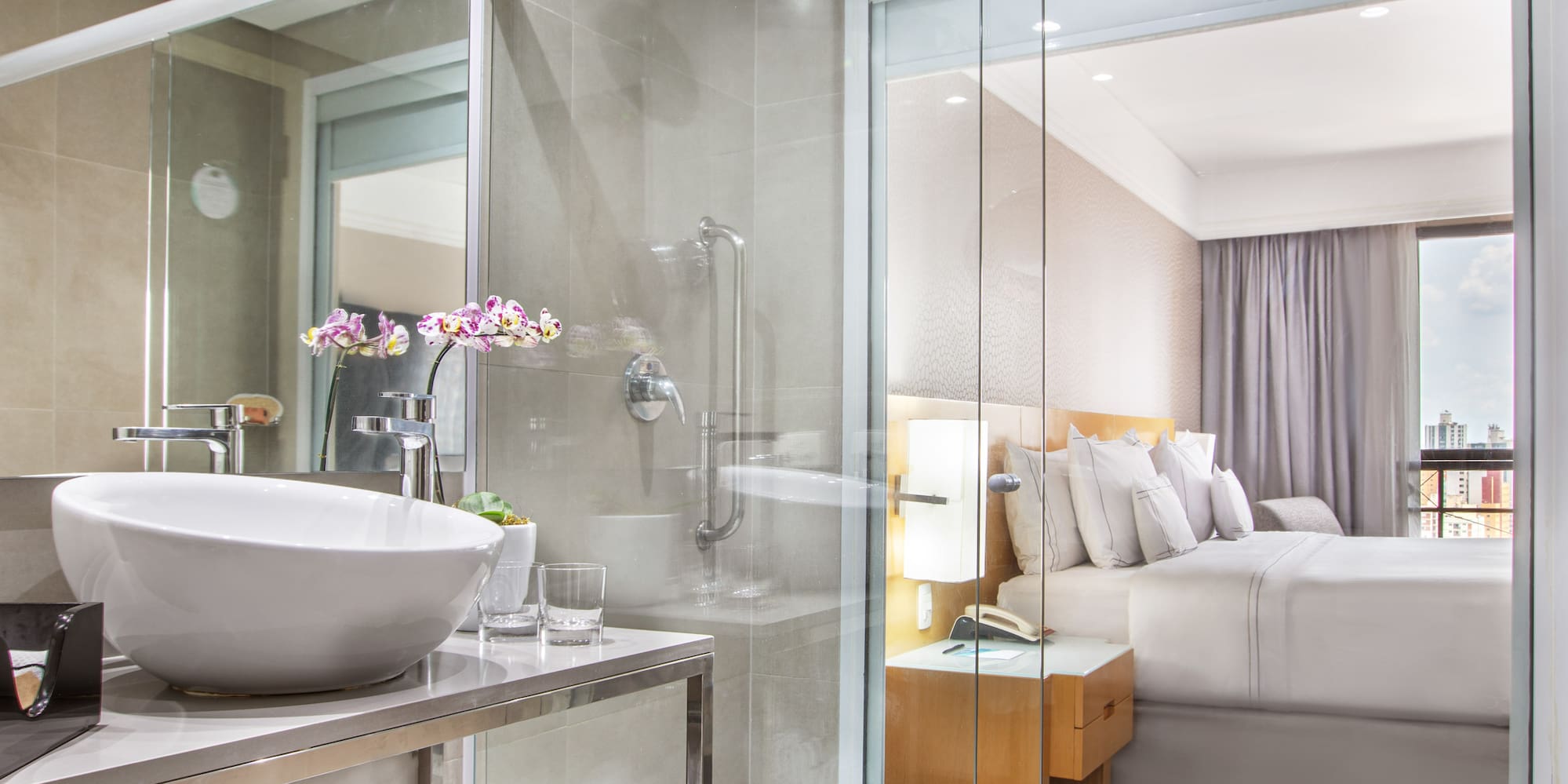 a bathroom with a glass shower and a sink