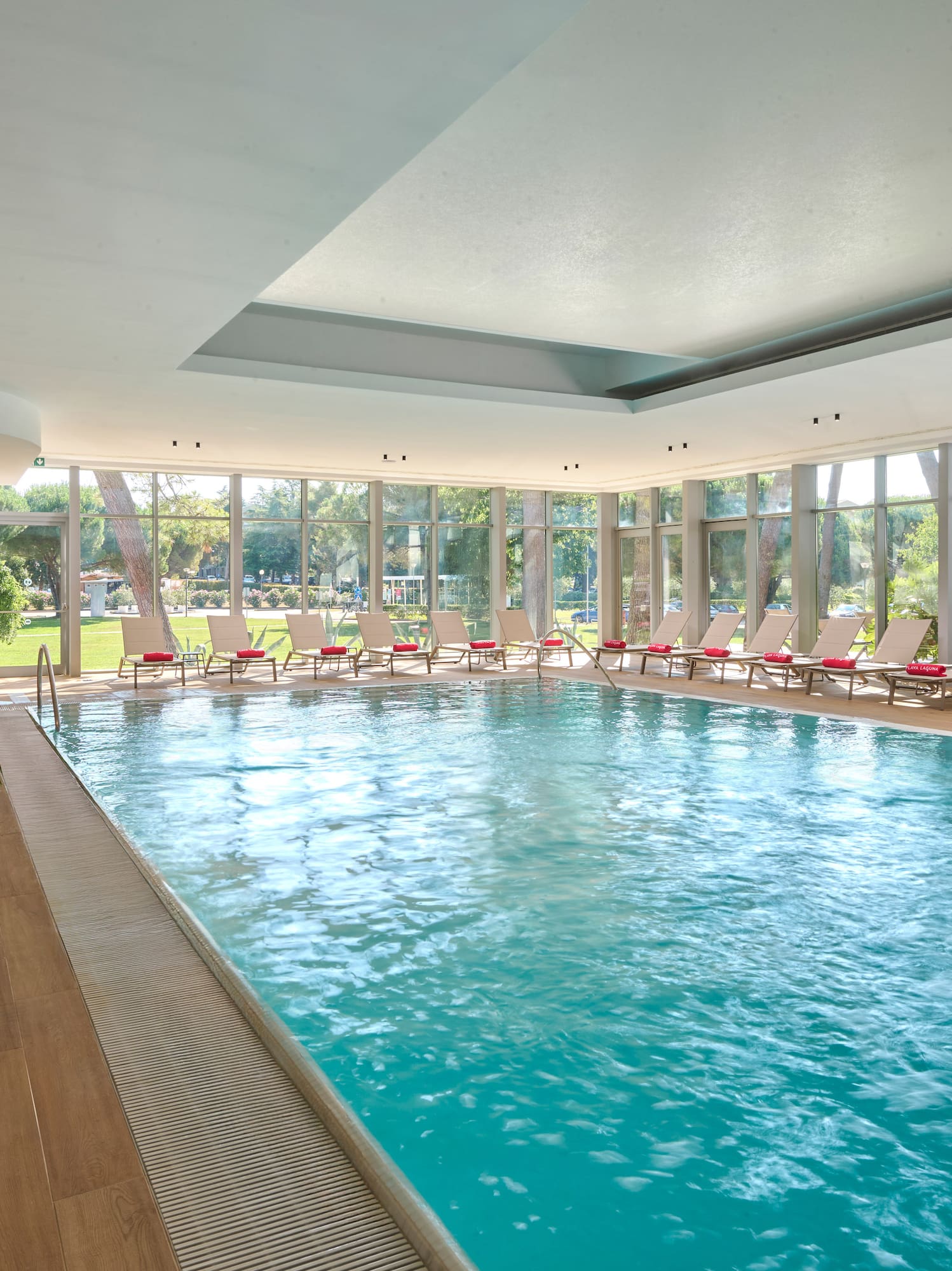 a swimming pool with chairs in the middle
