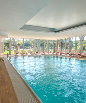 a swimming pool with chairs in the middle