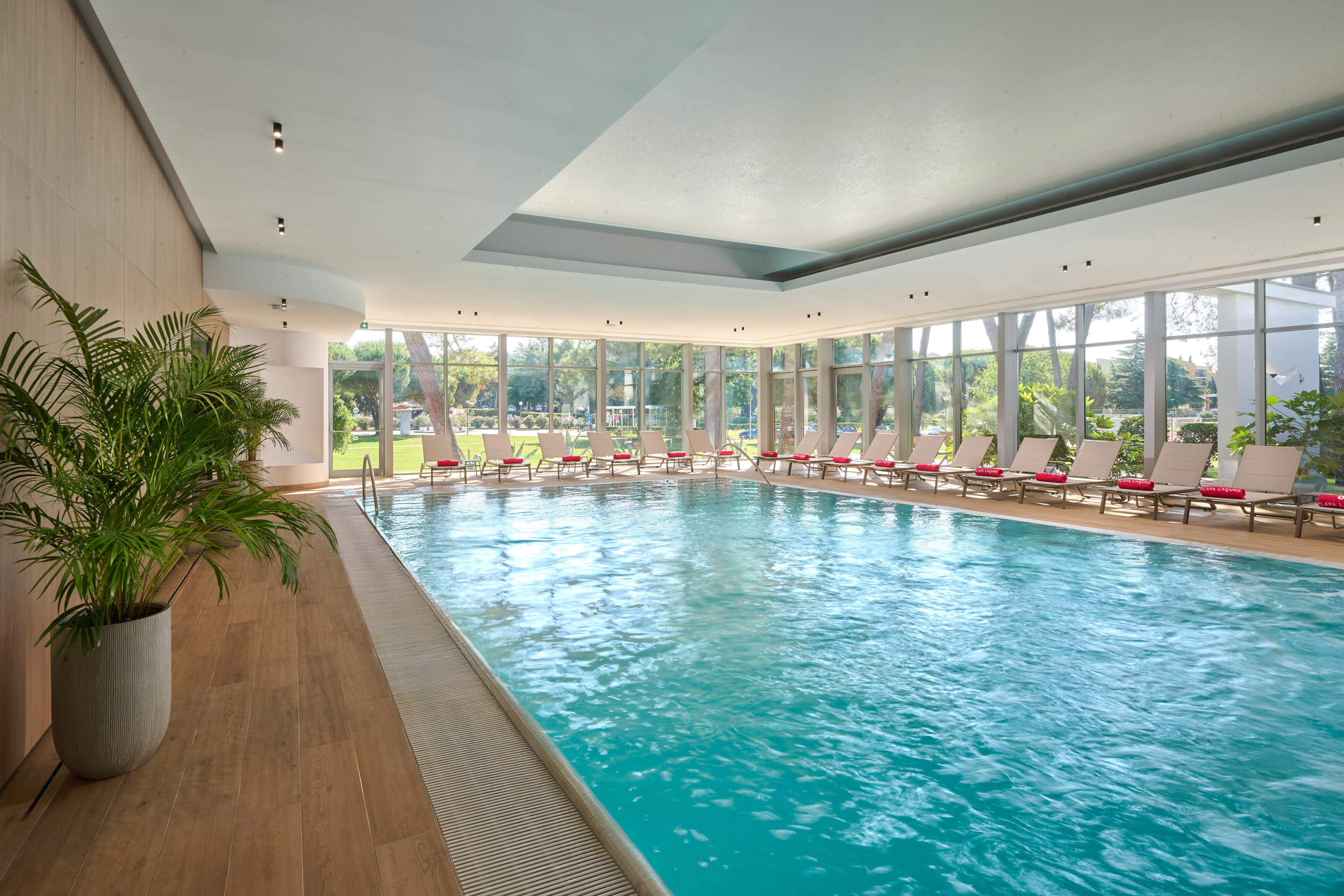 a swimming pool with chairs in the middle