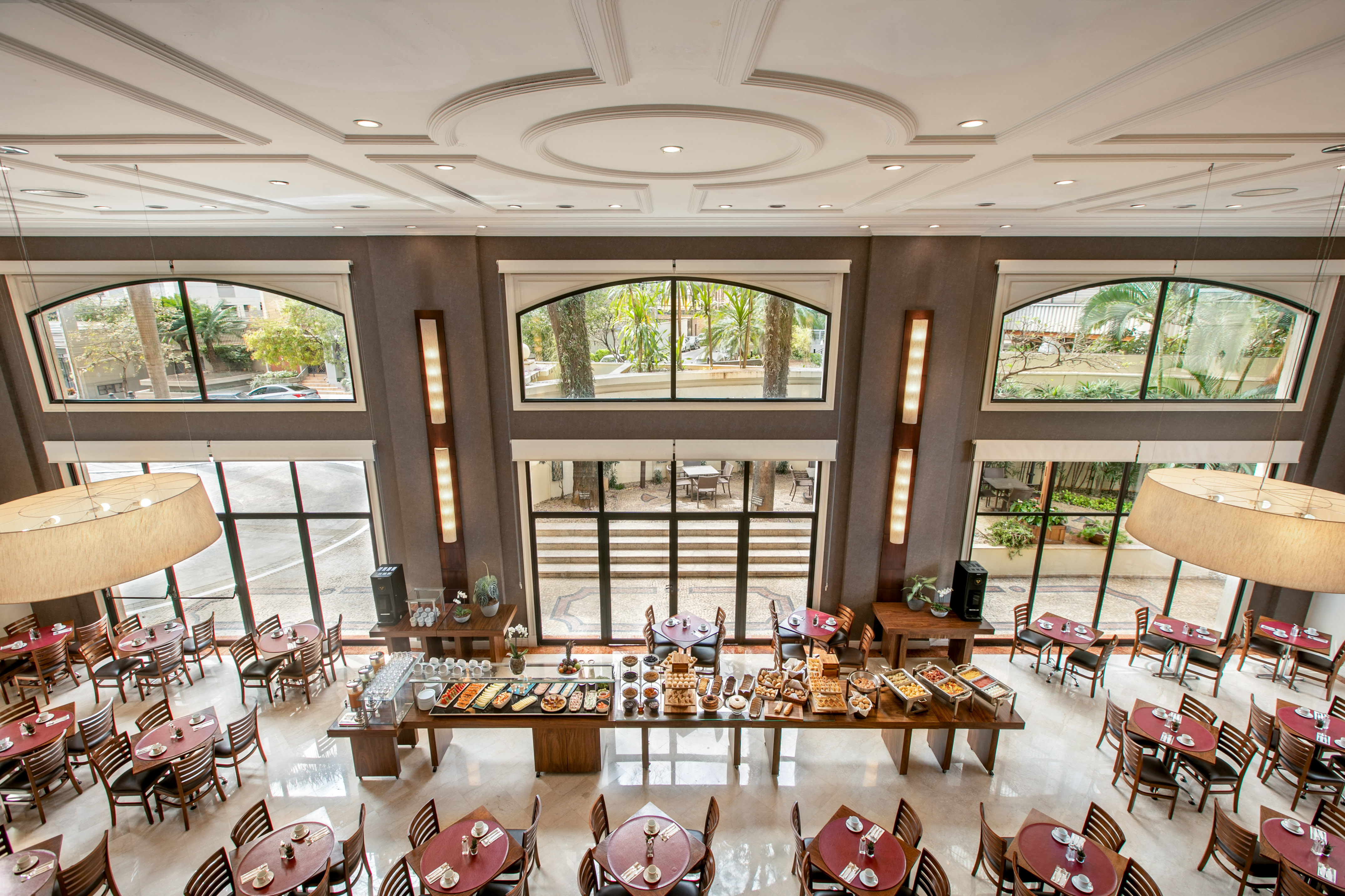 Spacious modern hotel dining room, breakfast buffet, large windows.