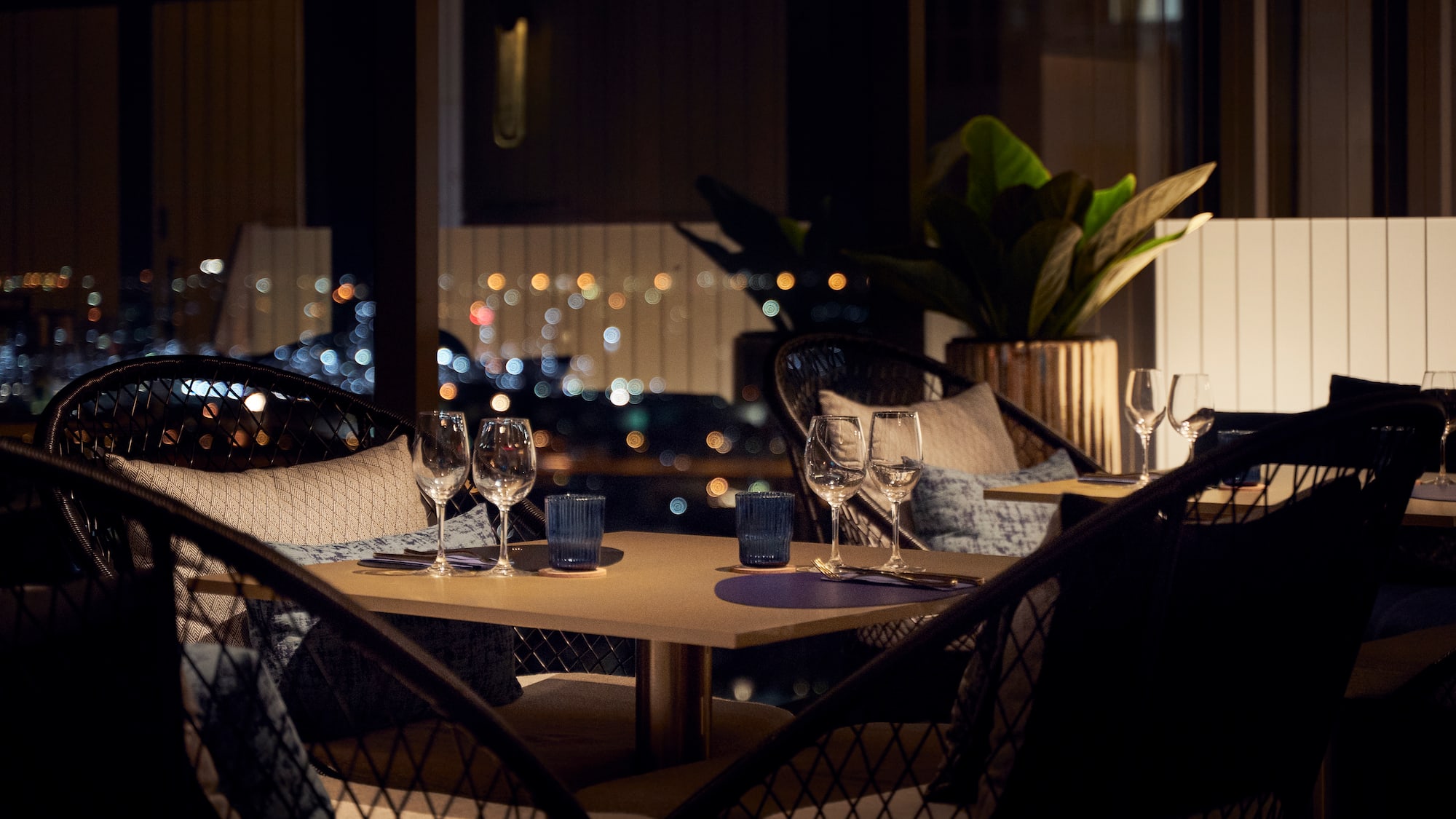 a table with wine glasses and candles on it