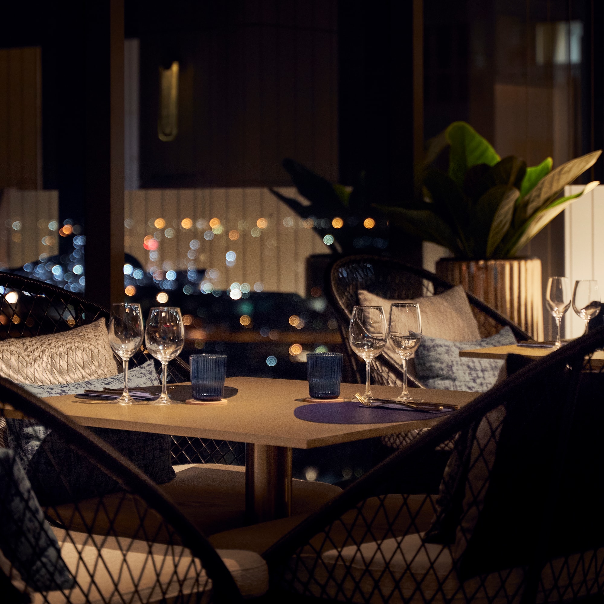 a table with wine glasses and candles on it
