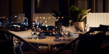 a table with wine glasses and candles on it