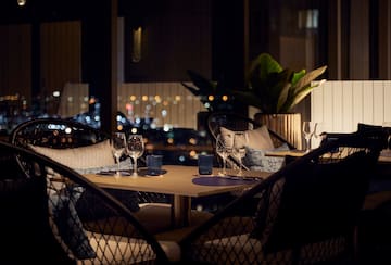 a table with wine glasses and candles on it