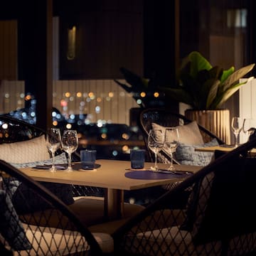 a table with wine glasses and candles on it