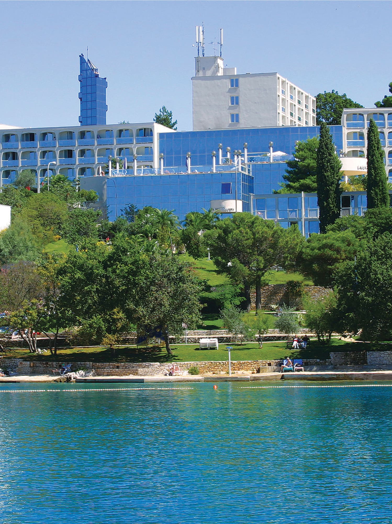 a body of water with buildings and trees