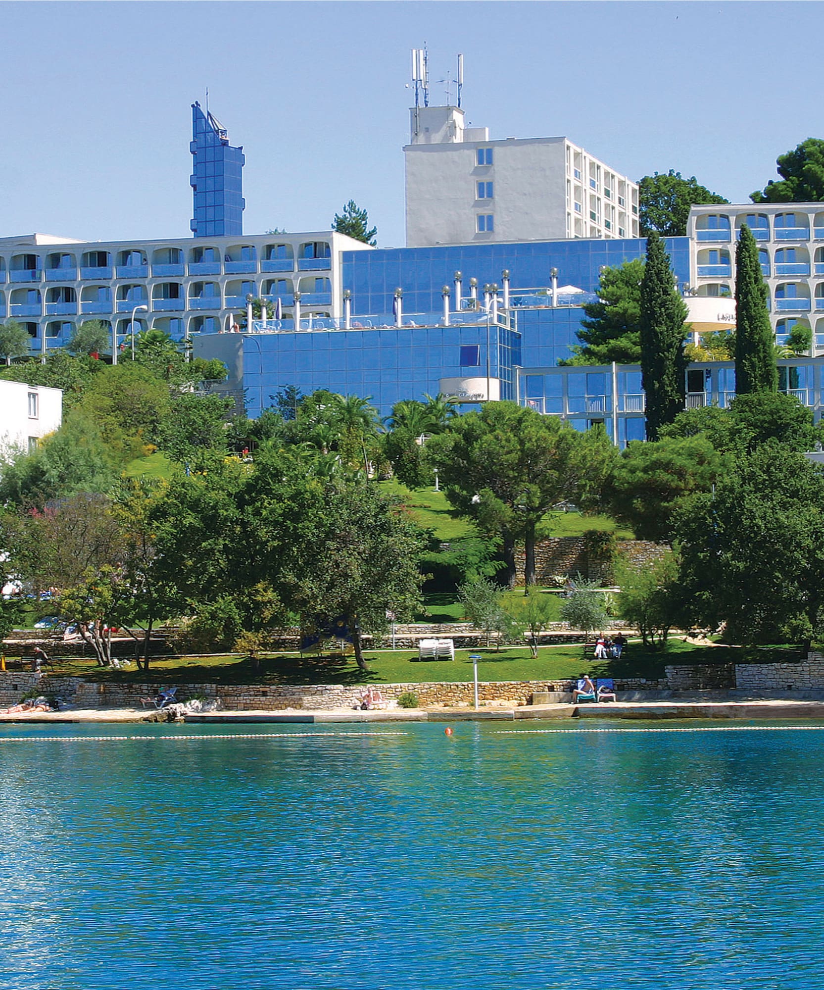 a body of water with buildings and trees