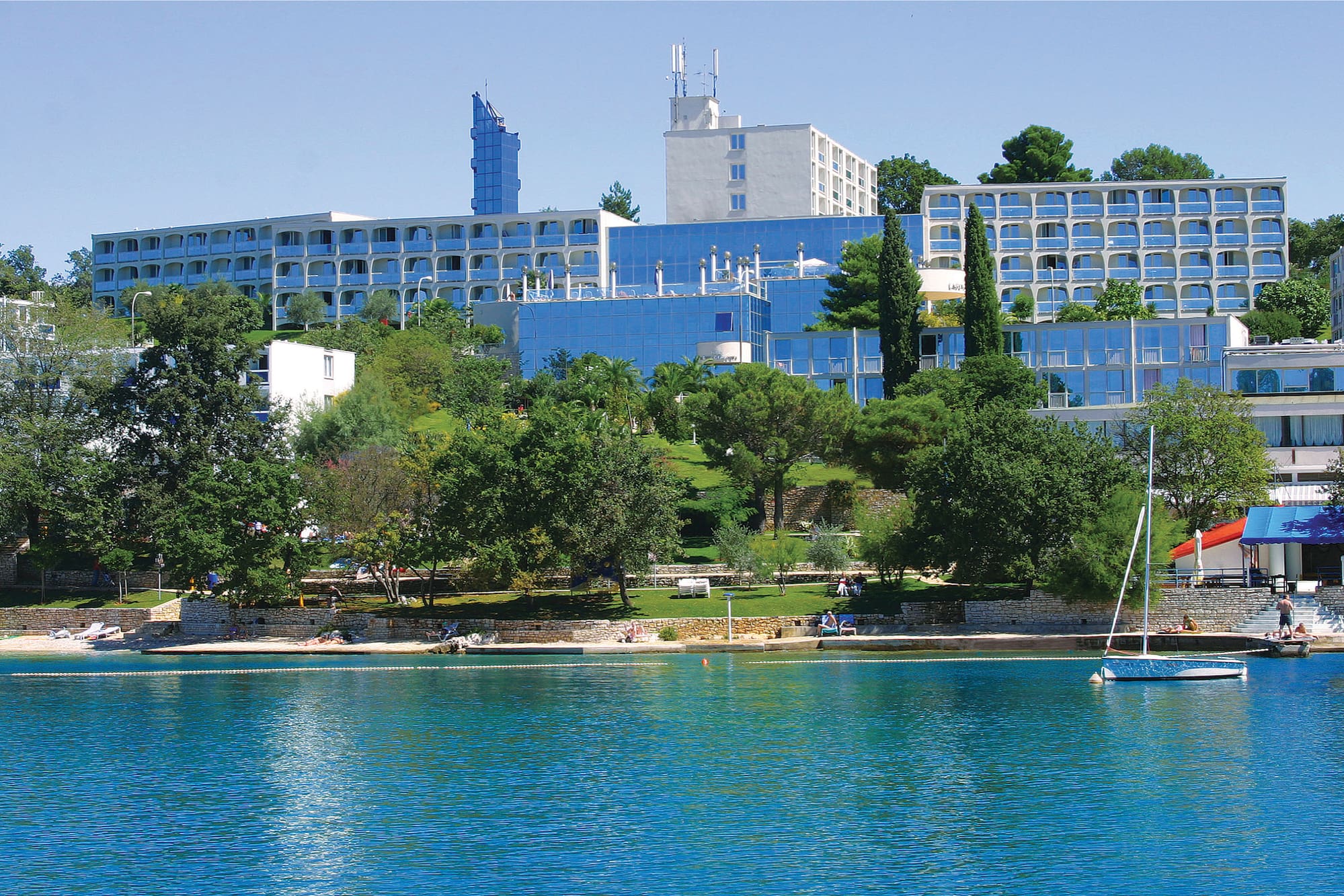 a body of water with buildings and trees