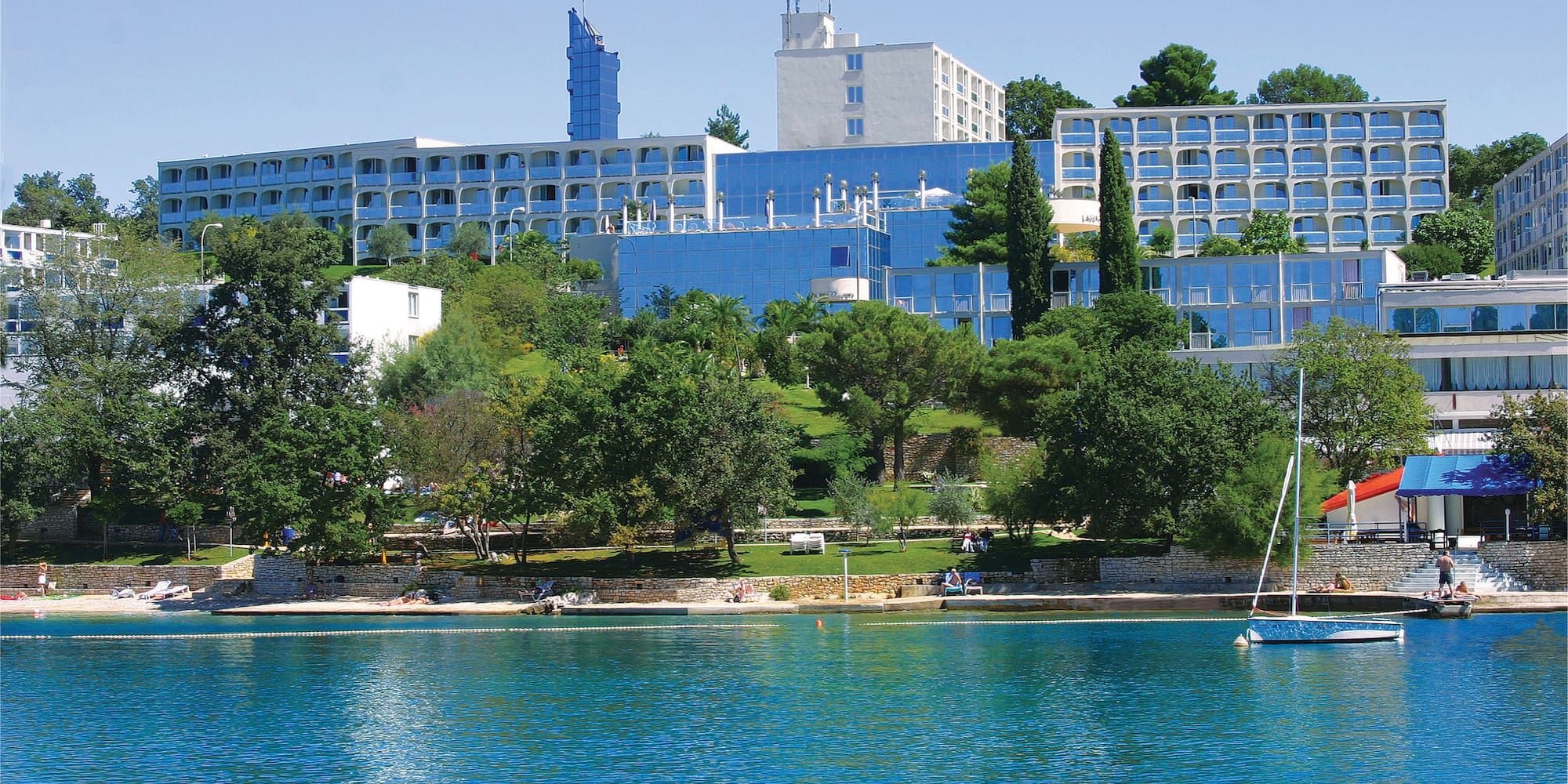 a body of water with buildings and trees