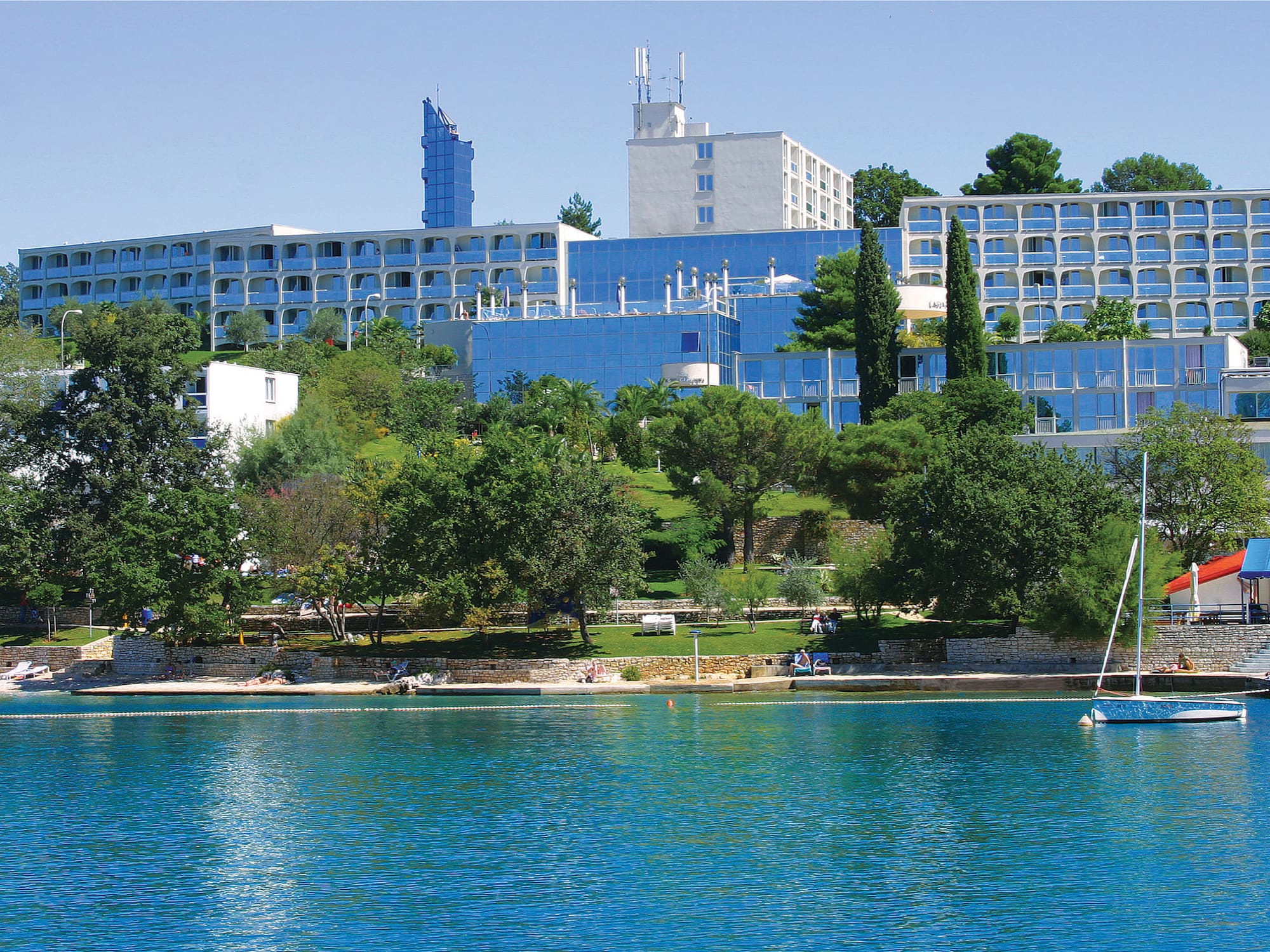 a body of water with buildings and trees