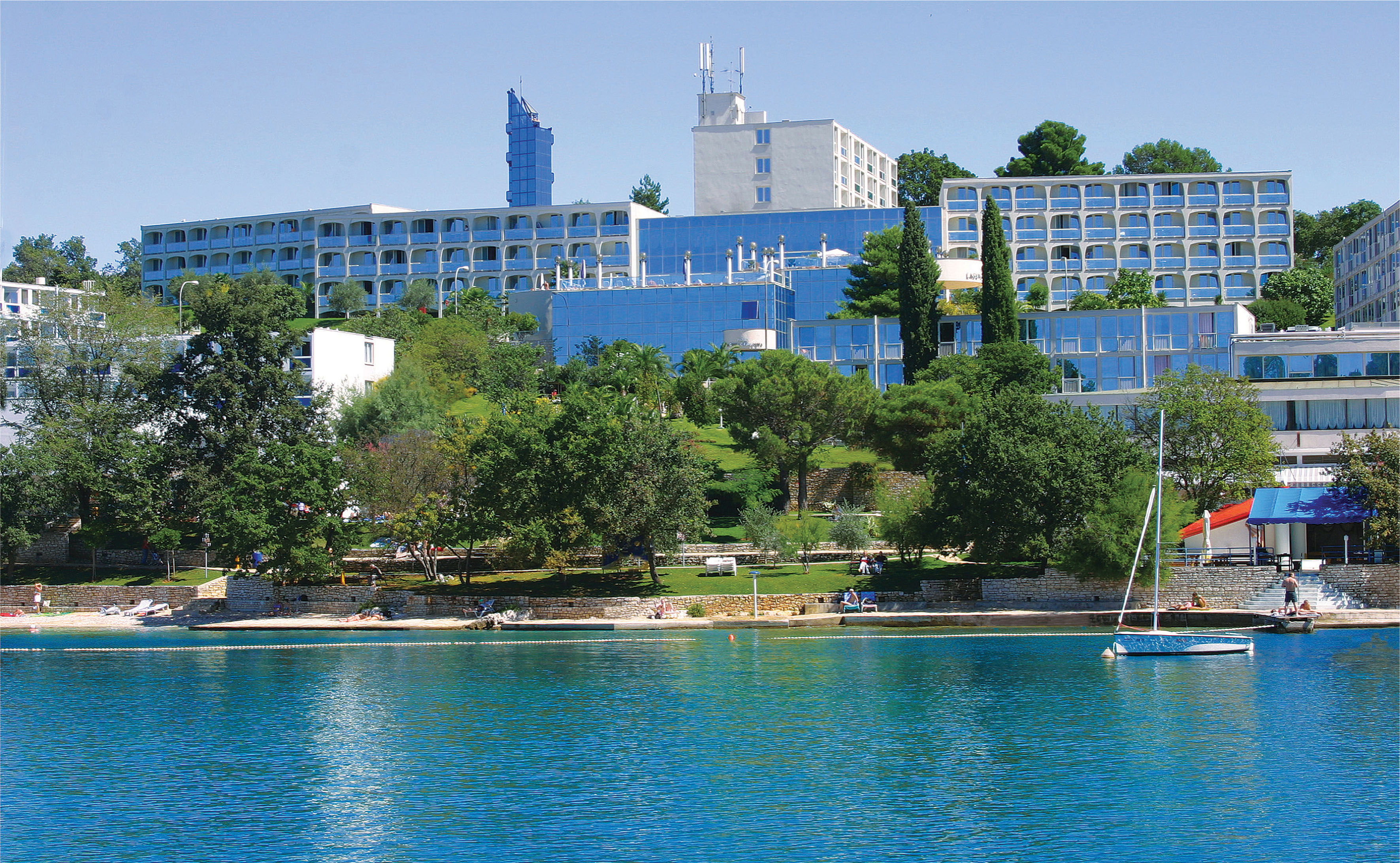 a body of water with buildings and trees