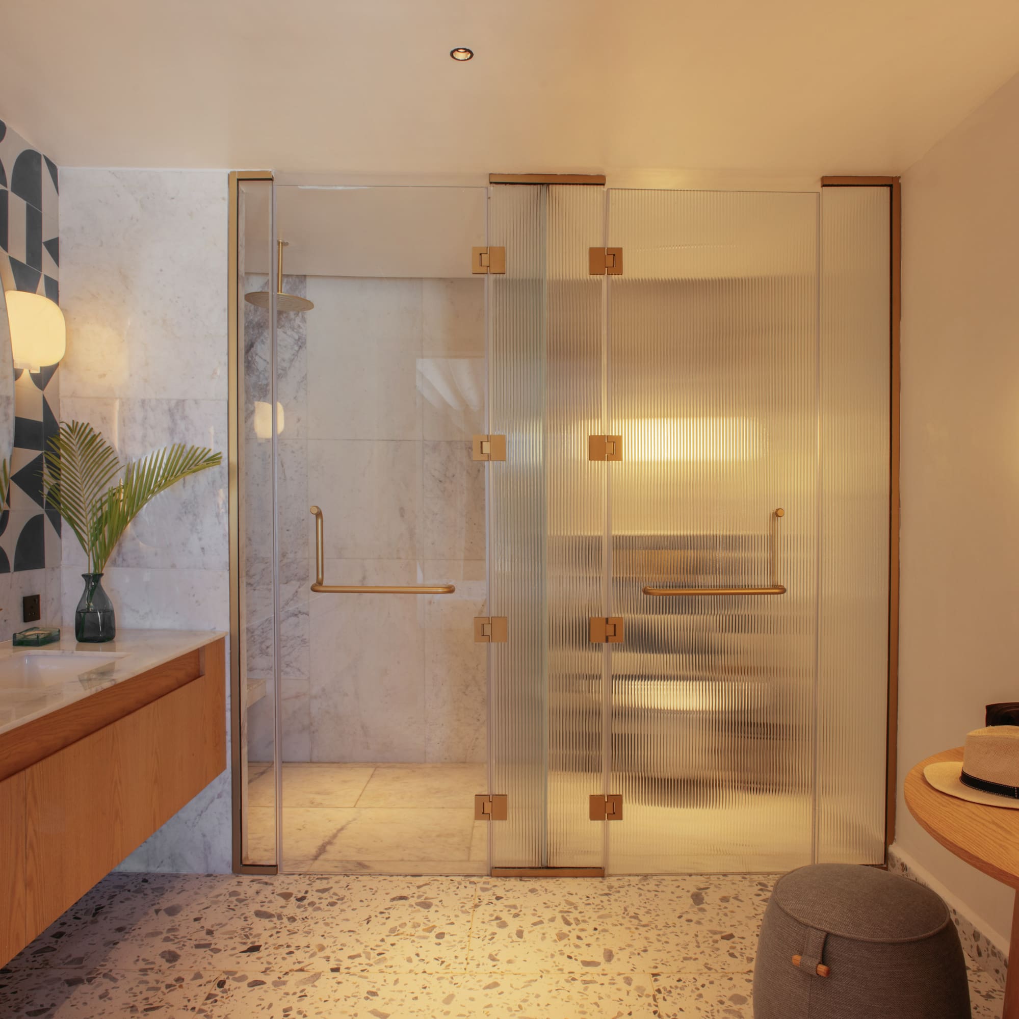a bathroom with a glass shower door