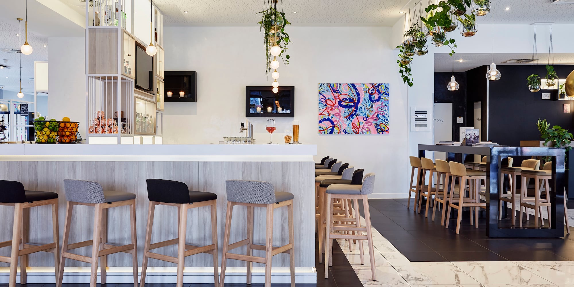 a bar with stools and a counter
