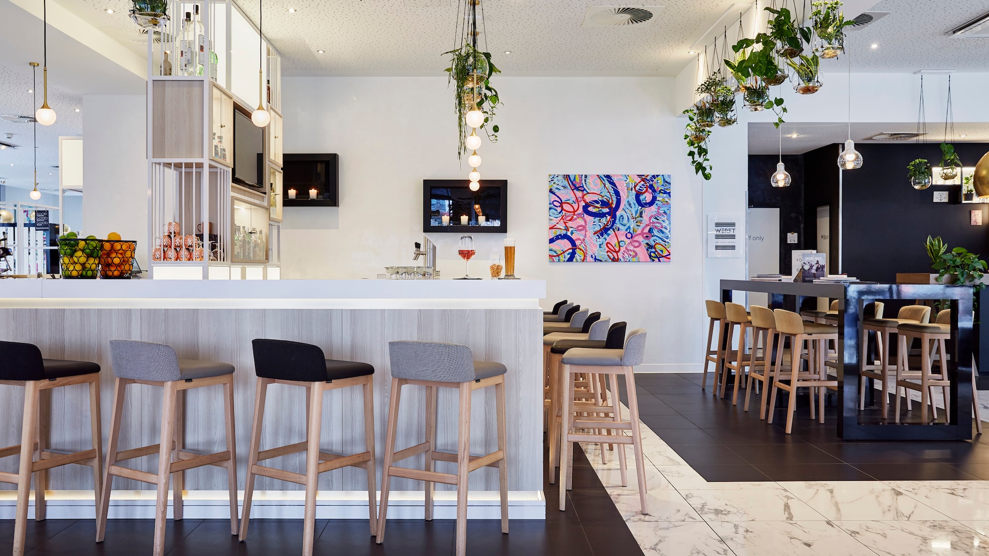 a bar with stools and a counter