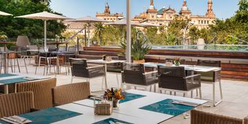 a patio with tables and chairs