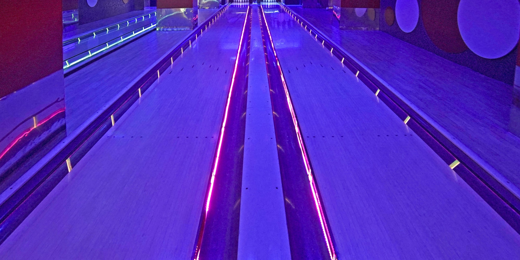 a bowling alley with purple lights