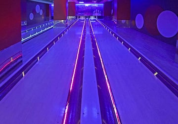 a bowling alley with purple lights