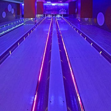 a bowling alley with purple lights