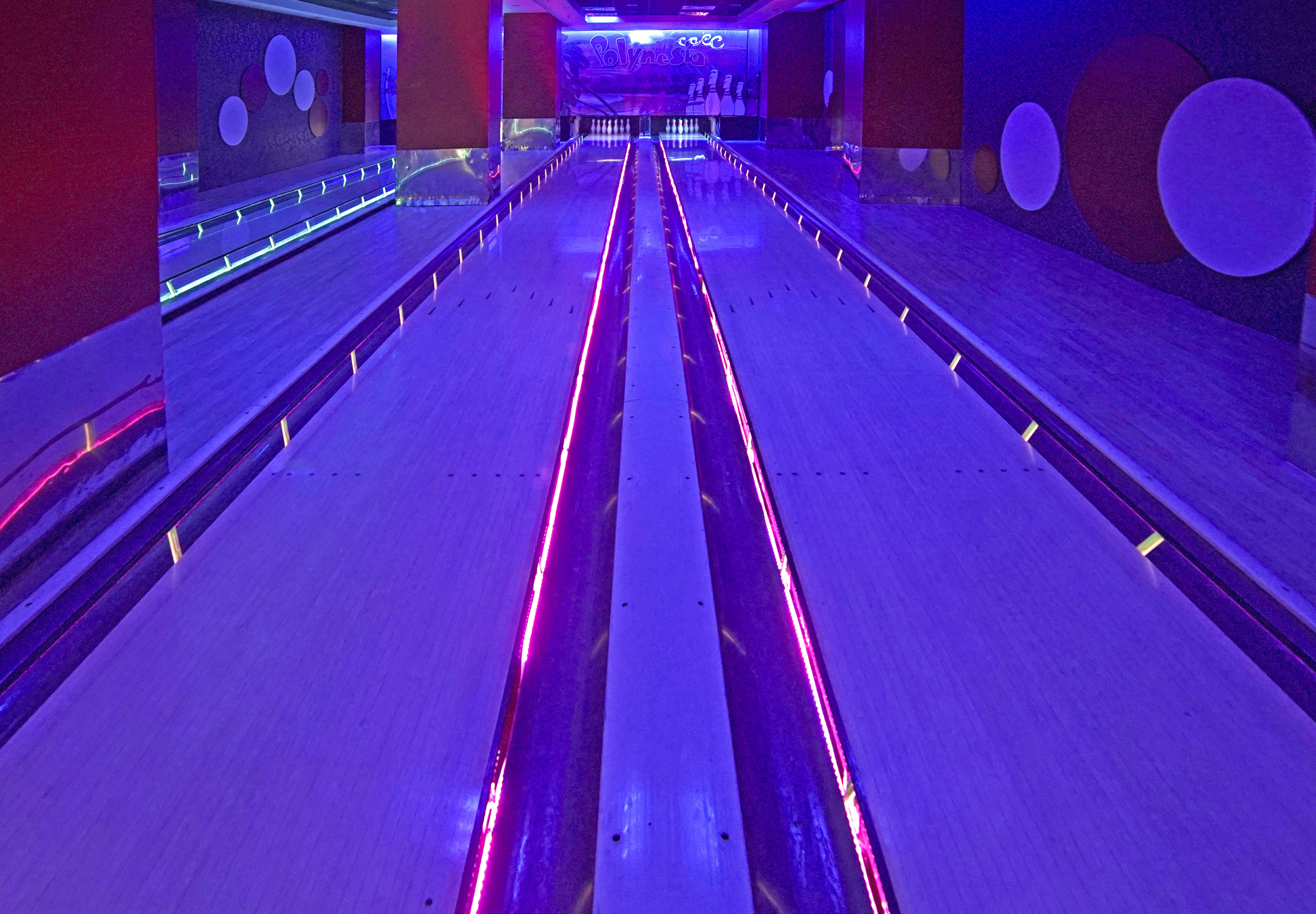 a bowling alley with purple lights