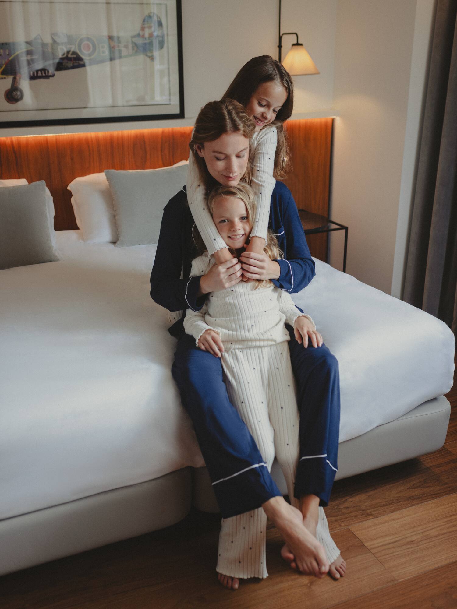a group of women sitting on a bed