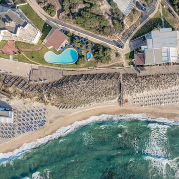 aerial view of a beach with a swimming pool and houses