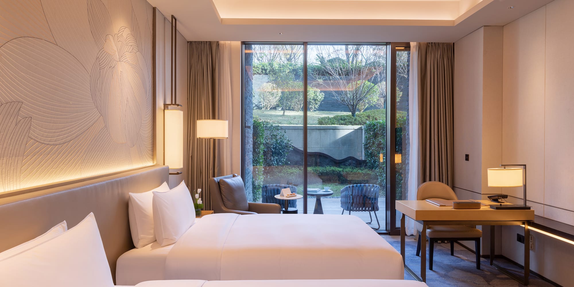 a room with two beds and a desk