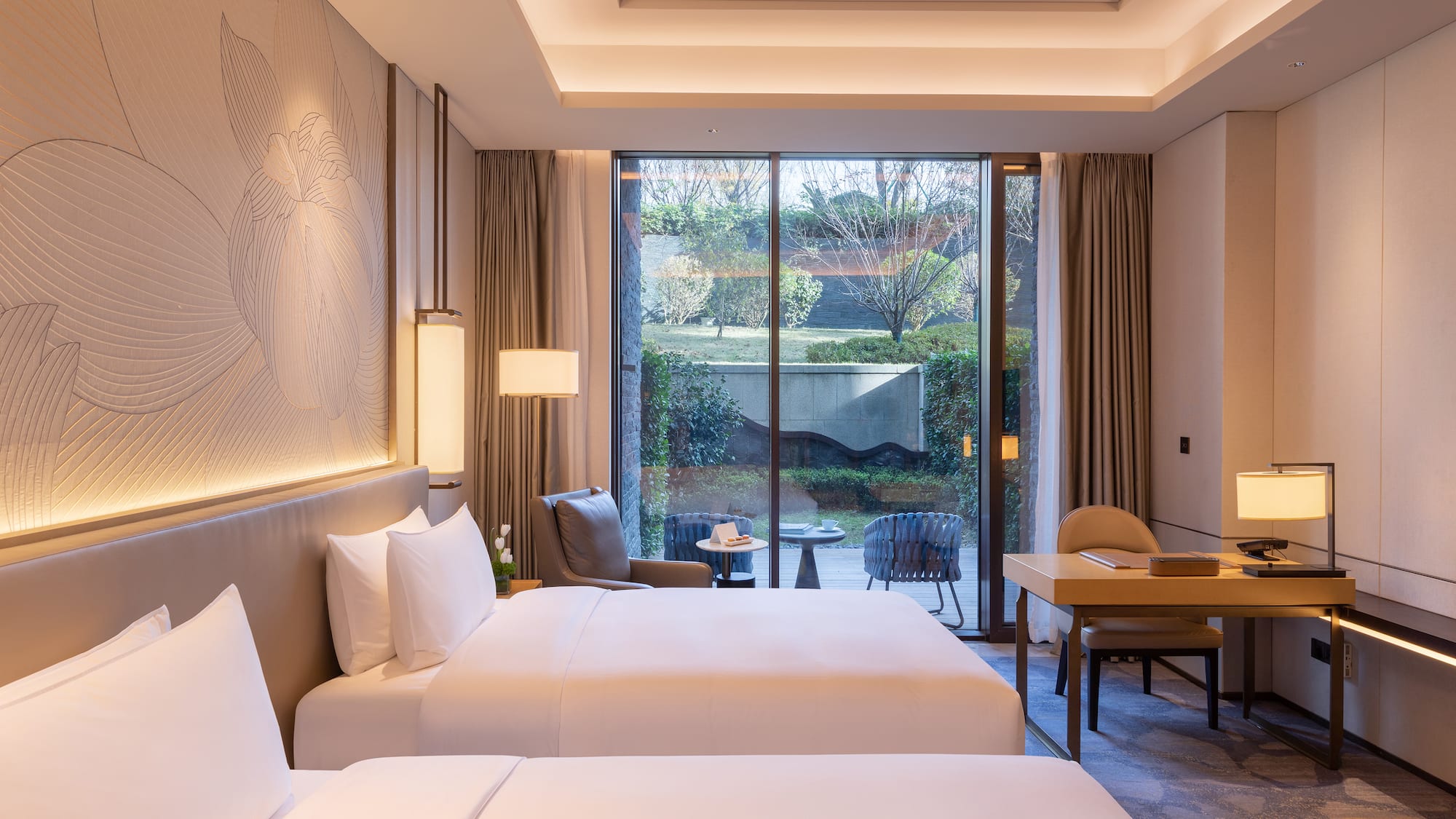 a room with two beds and a desk