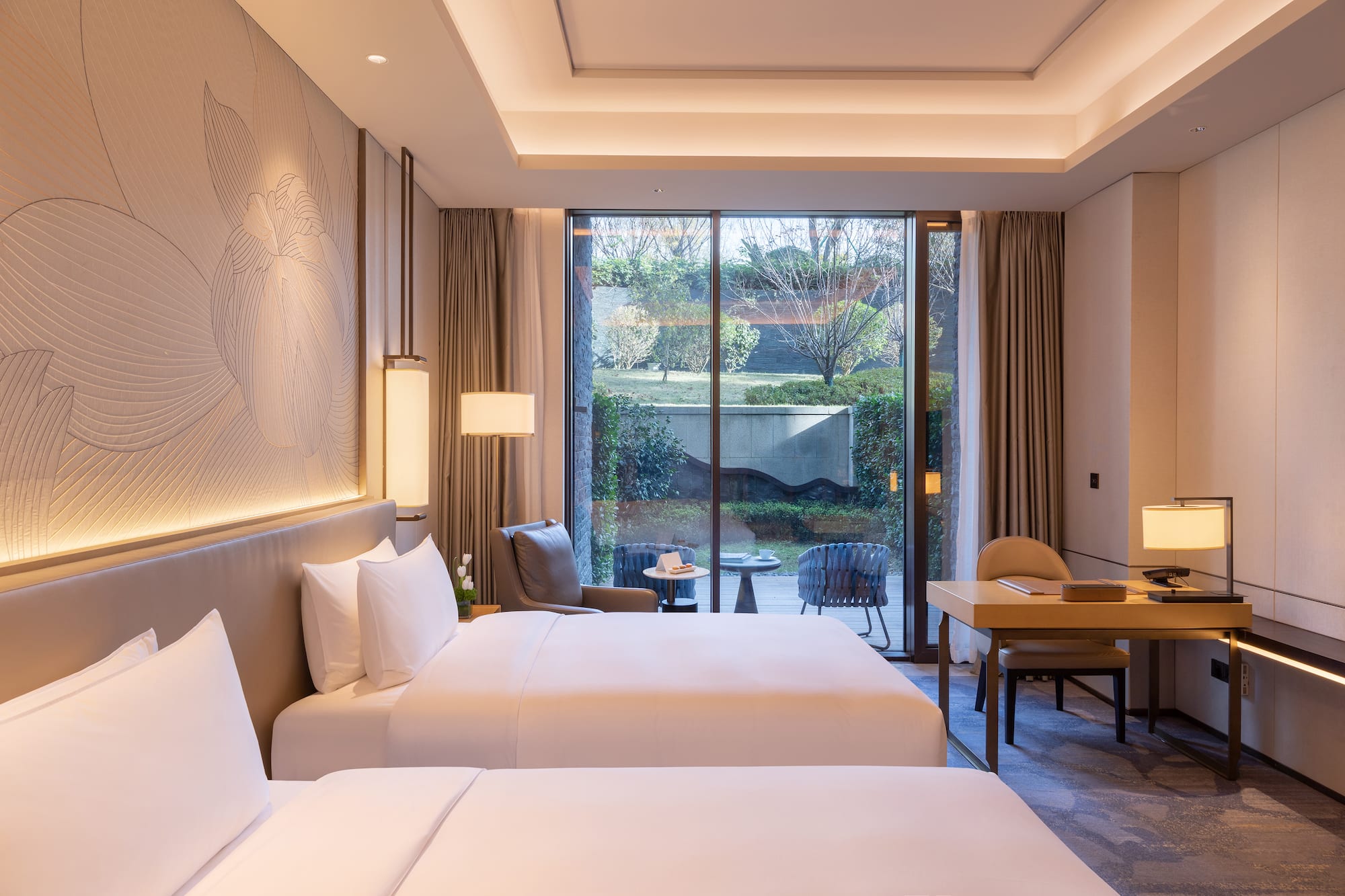 a room with two beds and a desk