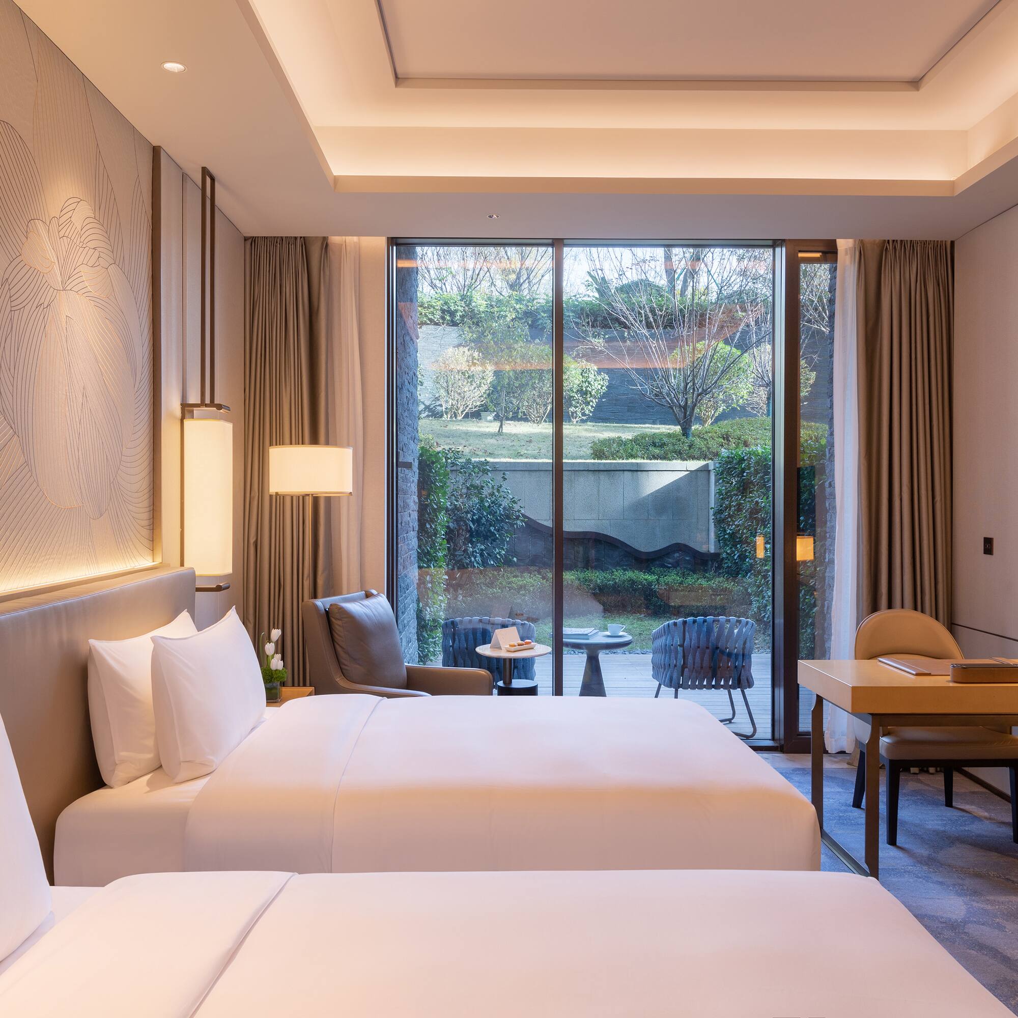 a room with two beds and a desk