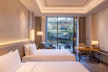 a room with two beds and a desk