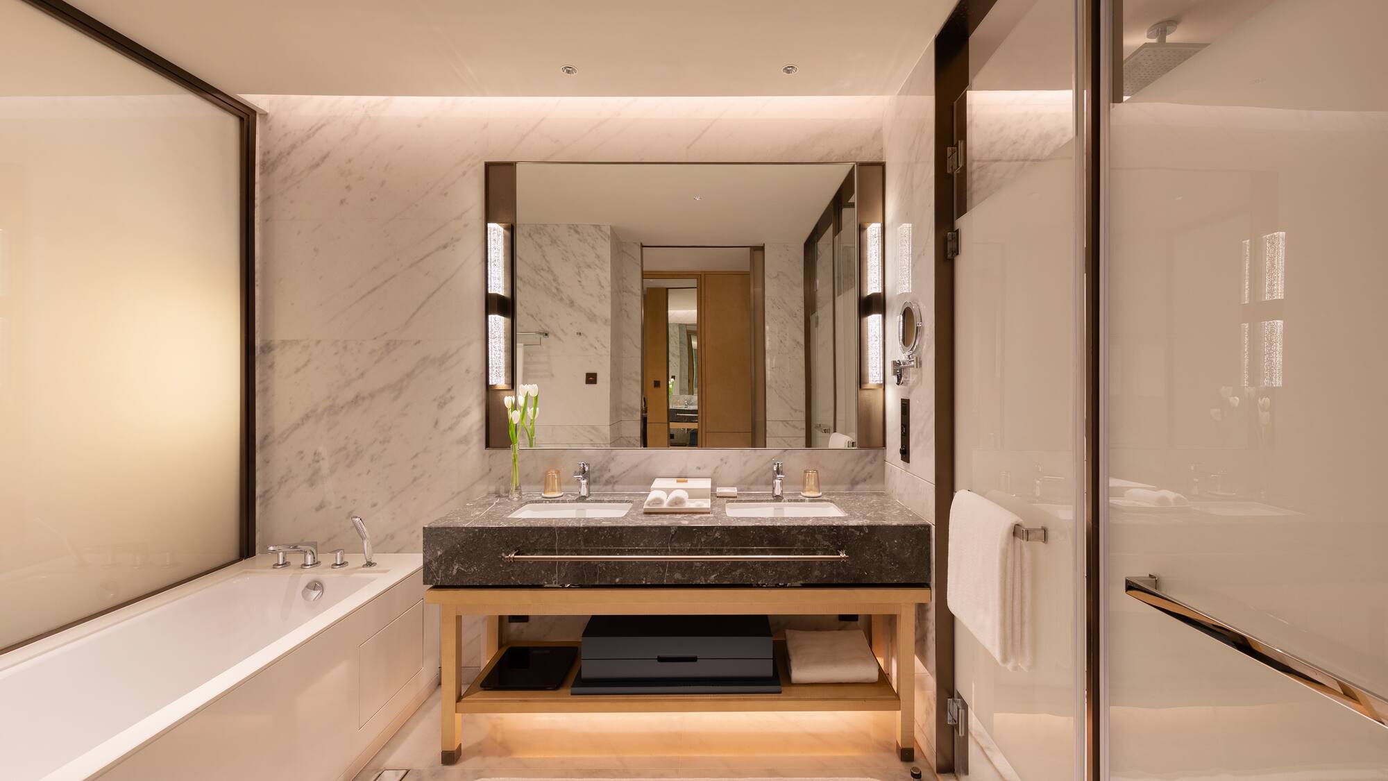 a bathroom with marble walls and a large mirror