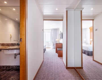 a hallway with a bed and a sink