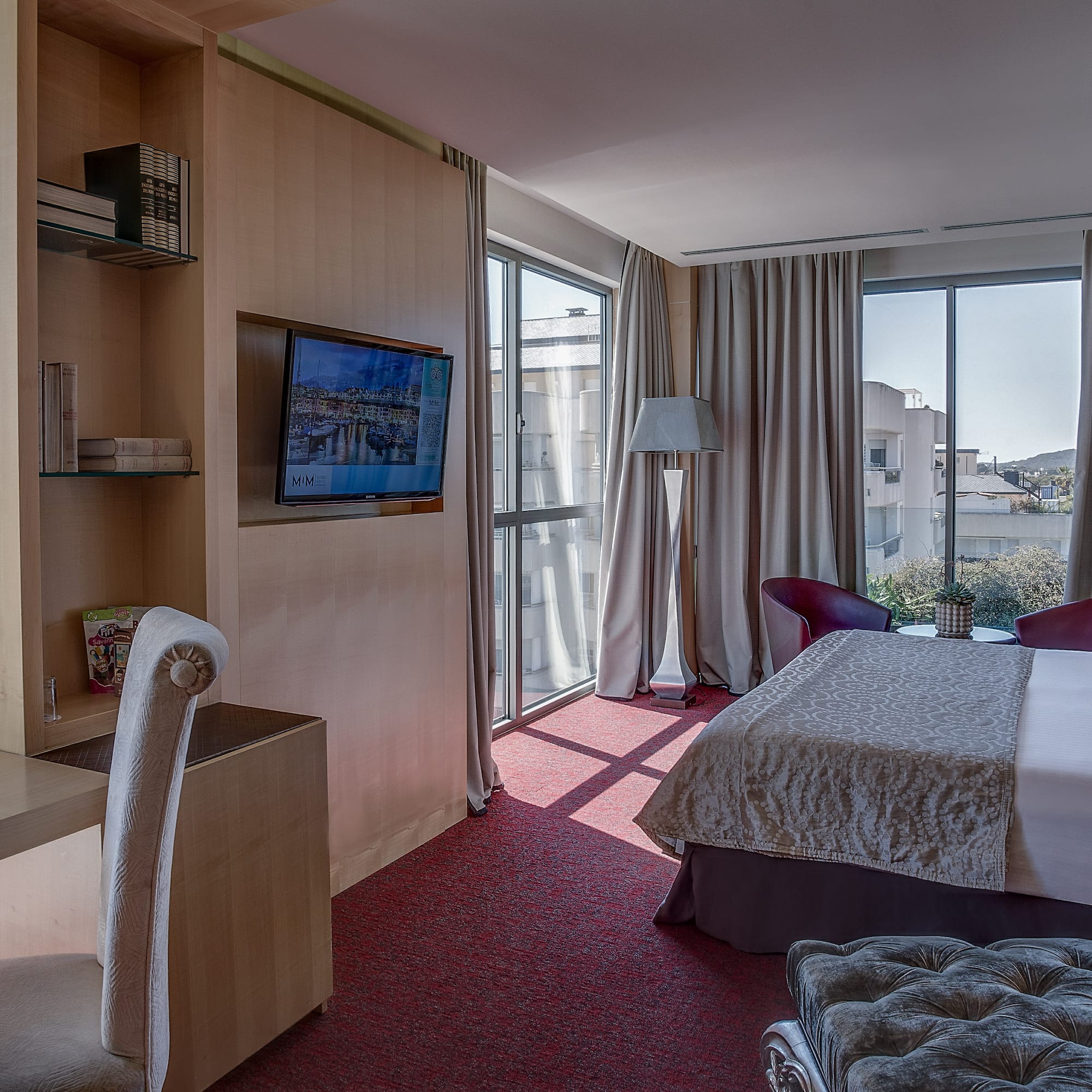 a room with a bed and a television