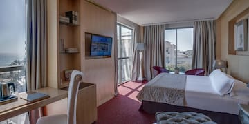 a room with a bed and a television