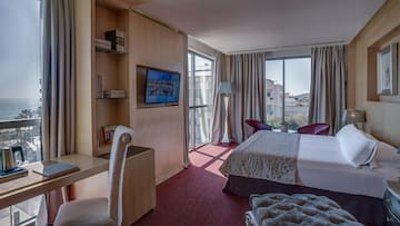 a room with a bed and a television