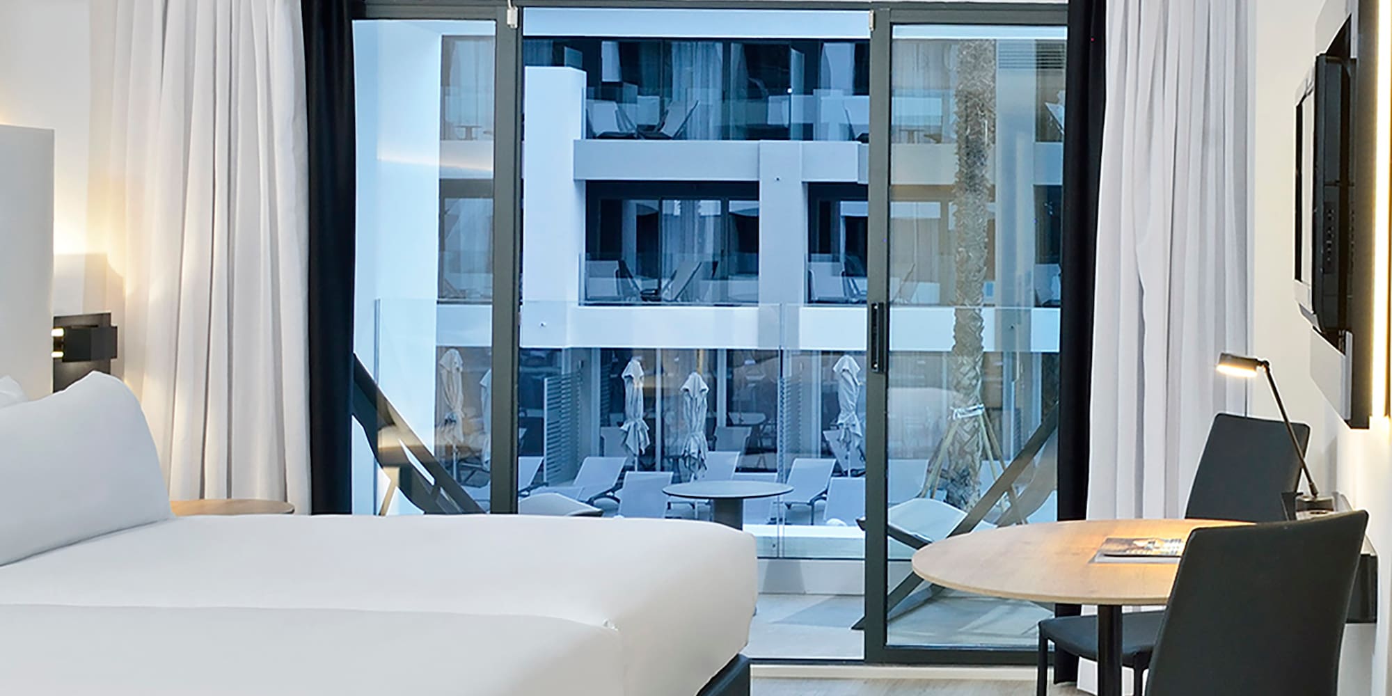 a room with two beds and a table