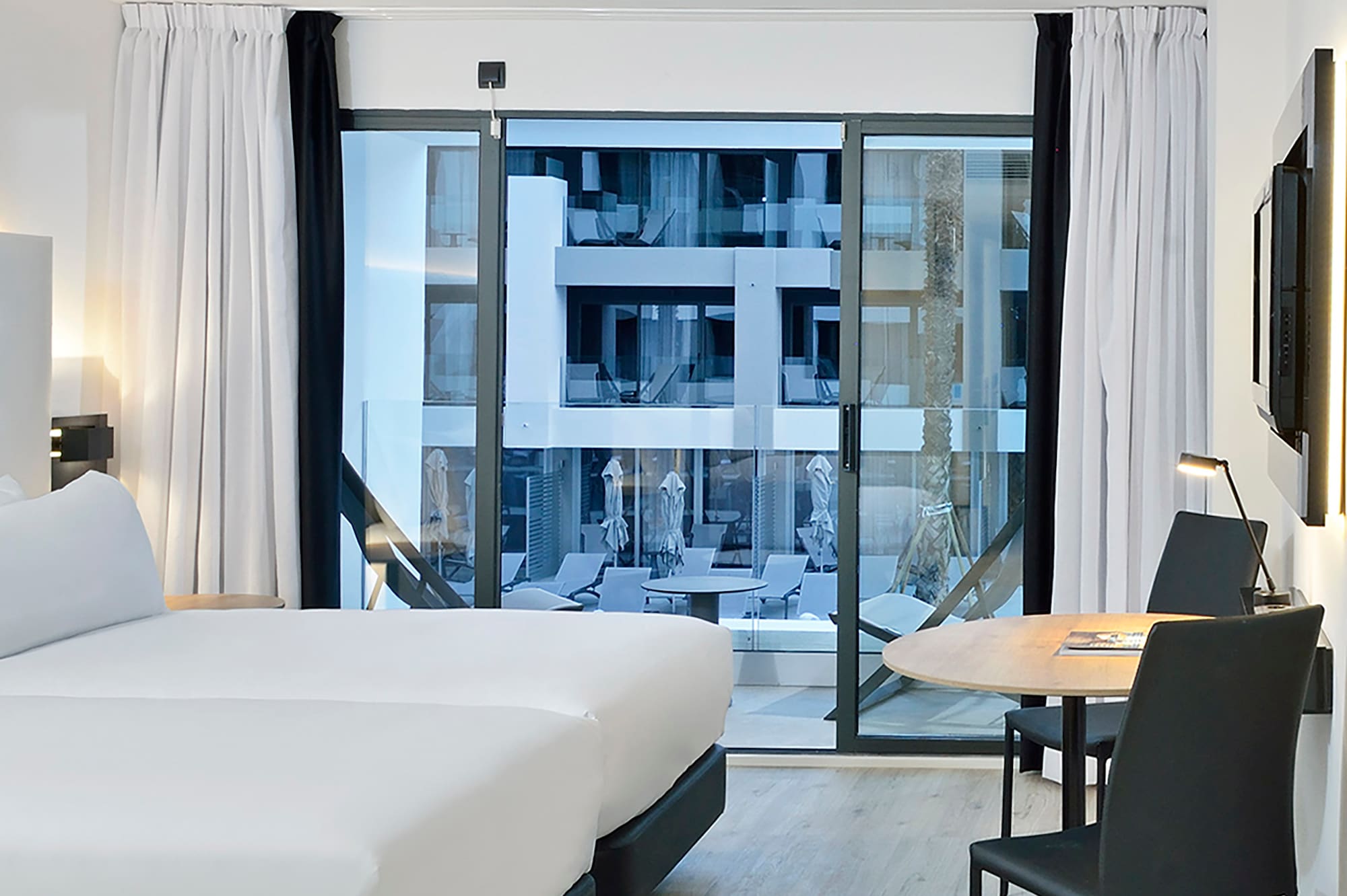 a room with two beds and a table